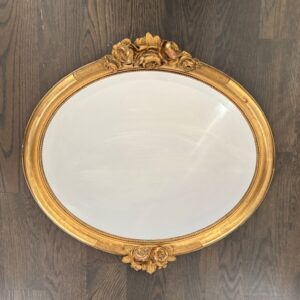 Gustavian style gilded oval mirror with hand carved florals